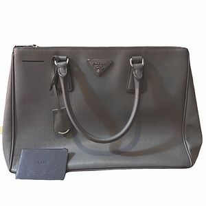 Gray Prada bag. Comes with verification card.